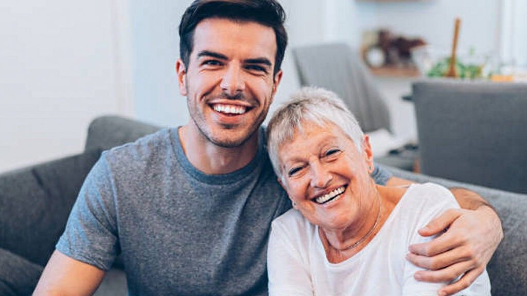 Young man old woman smiling hugging