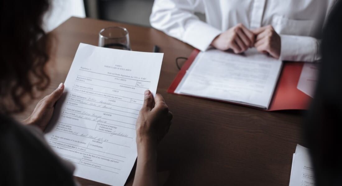 Parents holding new adoption papers.