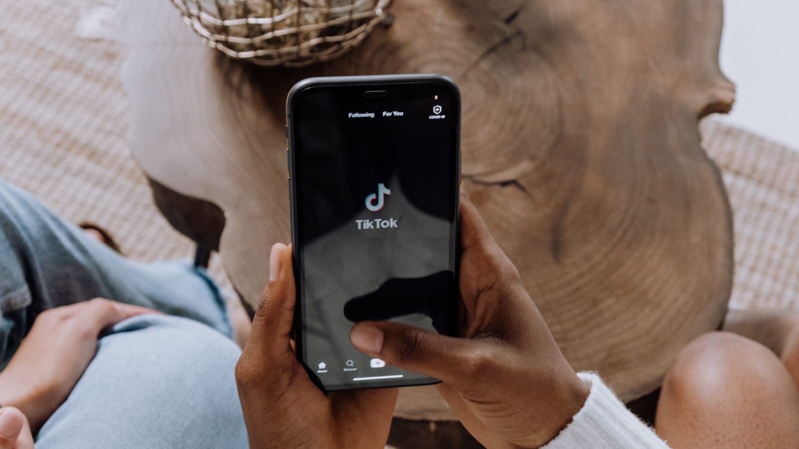 person holding a phone with tiktok app open on it
