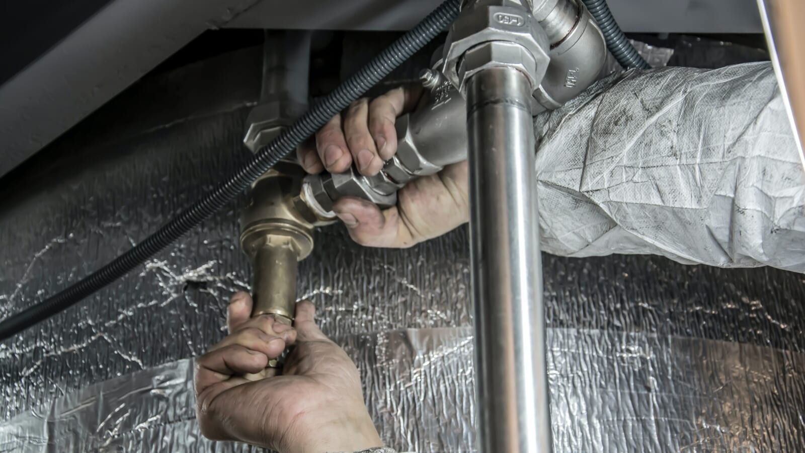 plumber fixing pipes