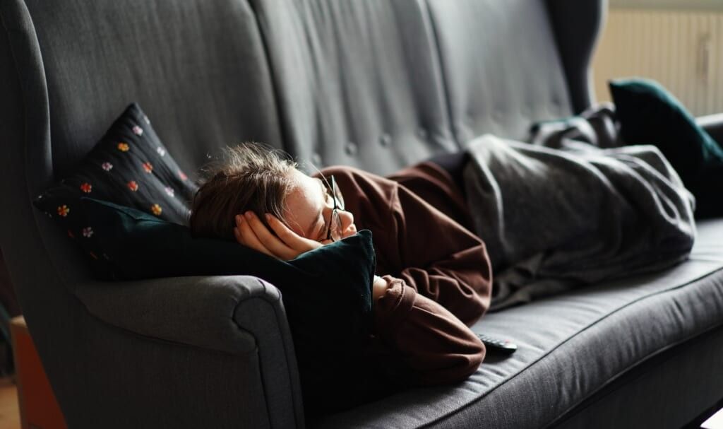 young lady lays on tv during the day