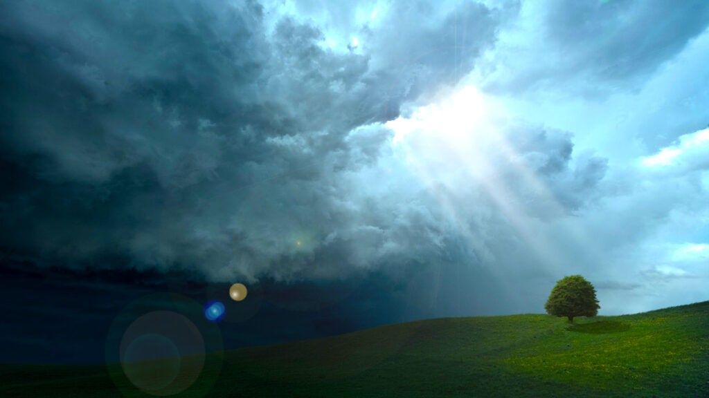 Open grass field with large clouds