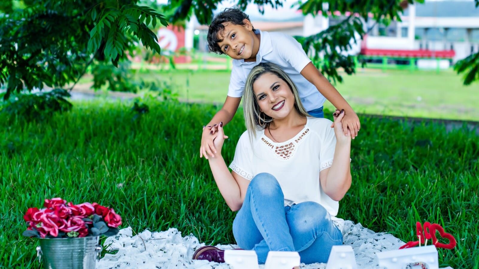 mom and son smiling on the grass