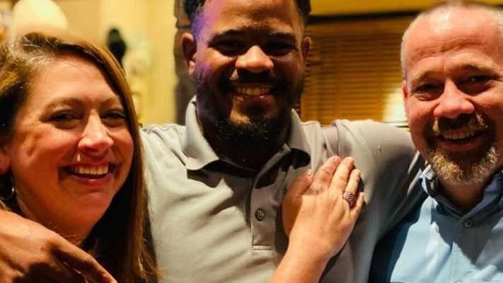 man standing in between a couple