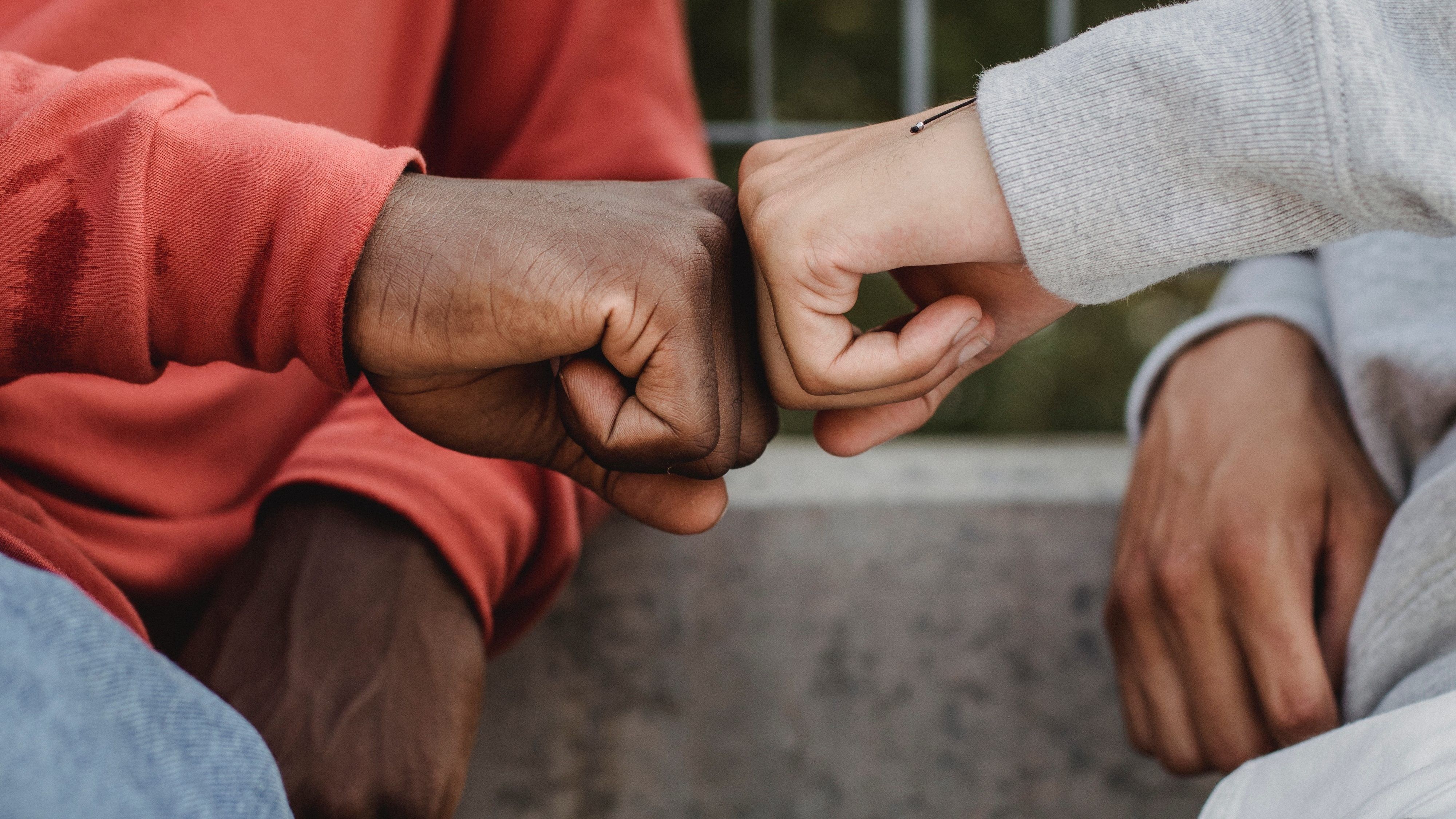 two boys fist bumping