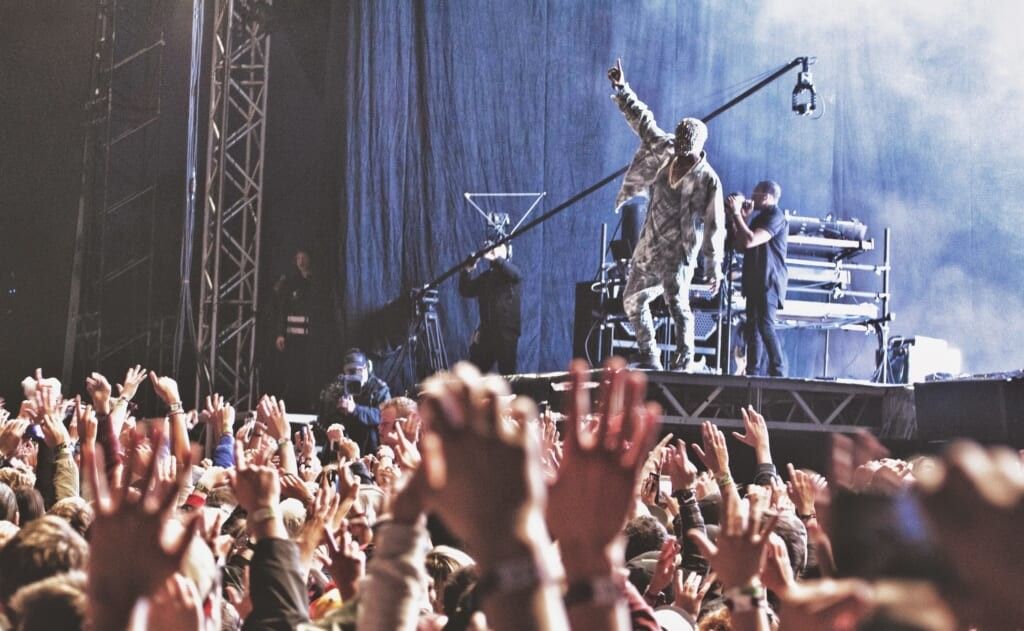 Kanye West holds fist up at concert