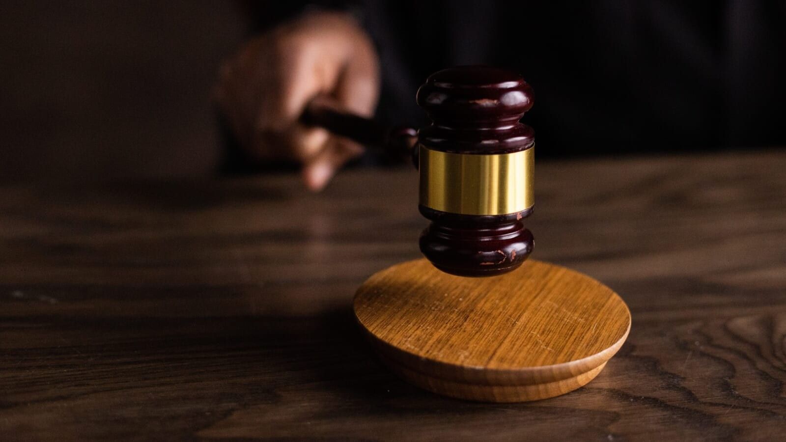 person banging a gavel on a table
