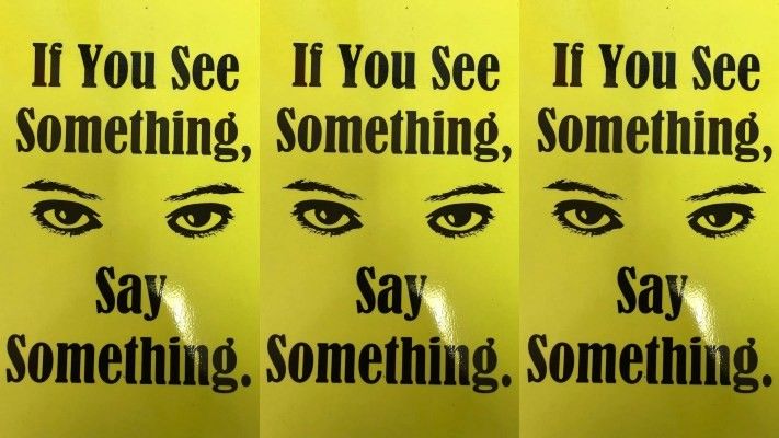 yellow posters with a pair of eyes at the center