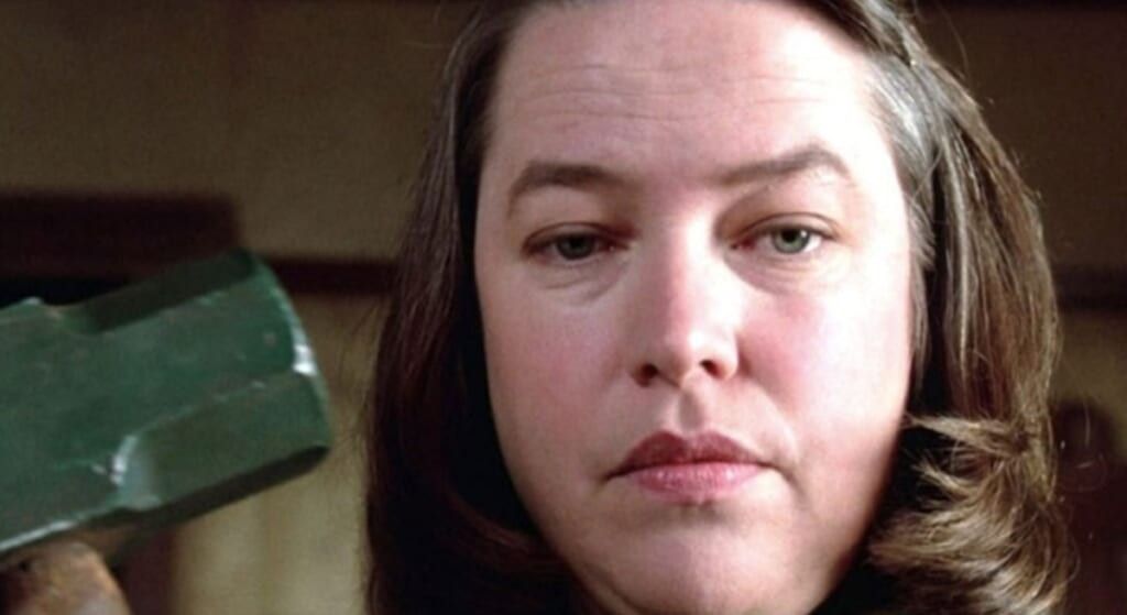 Kathy Bates in Misery holding a sledgehammer