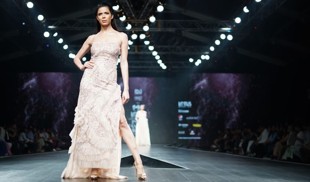 beautiful model wears dress on the runway