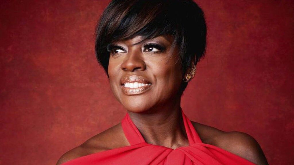 Viola Davis in red dress with a red background