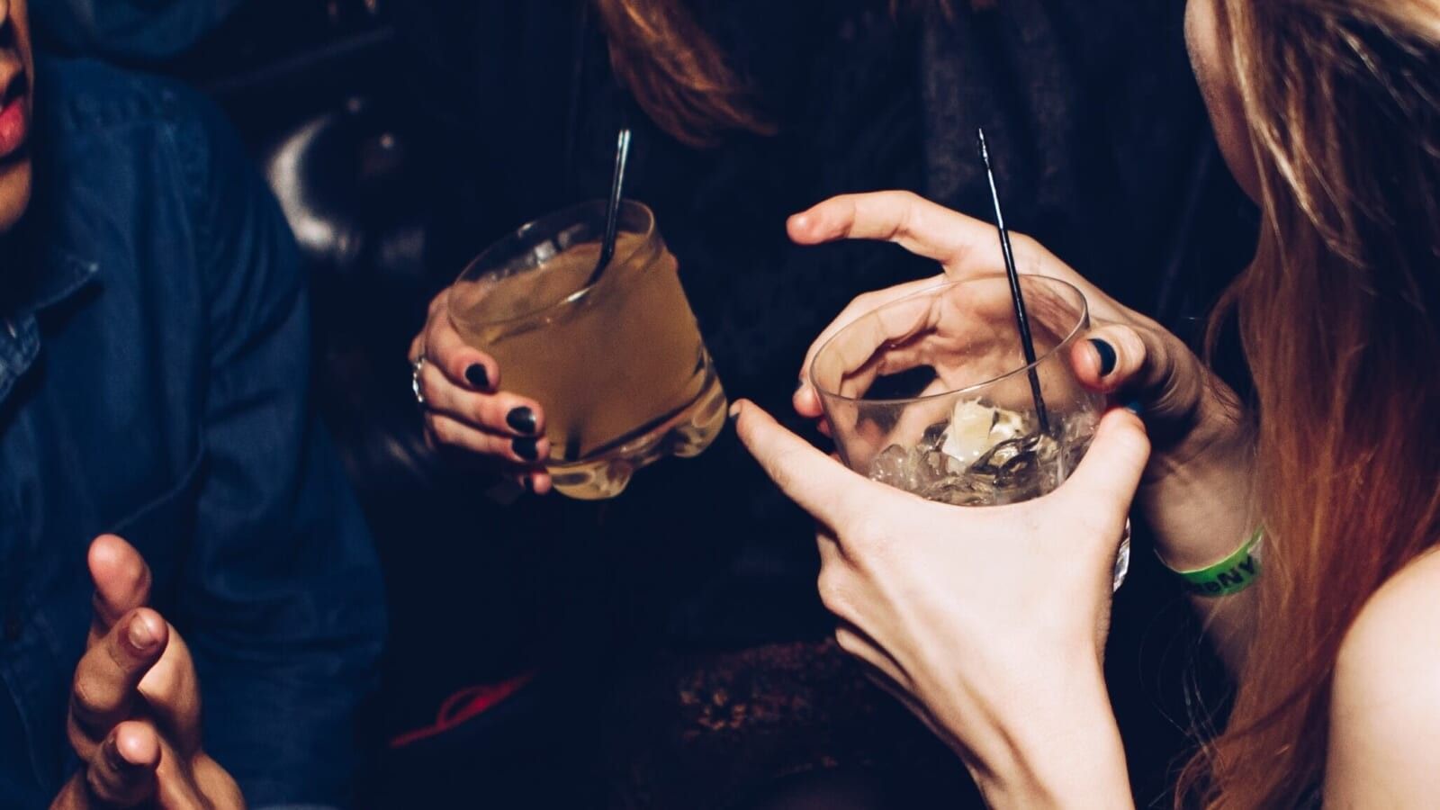people holding drinks at a club