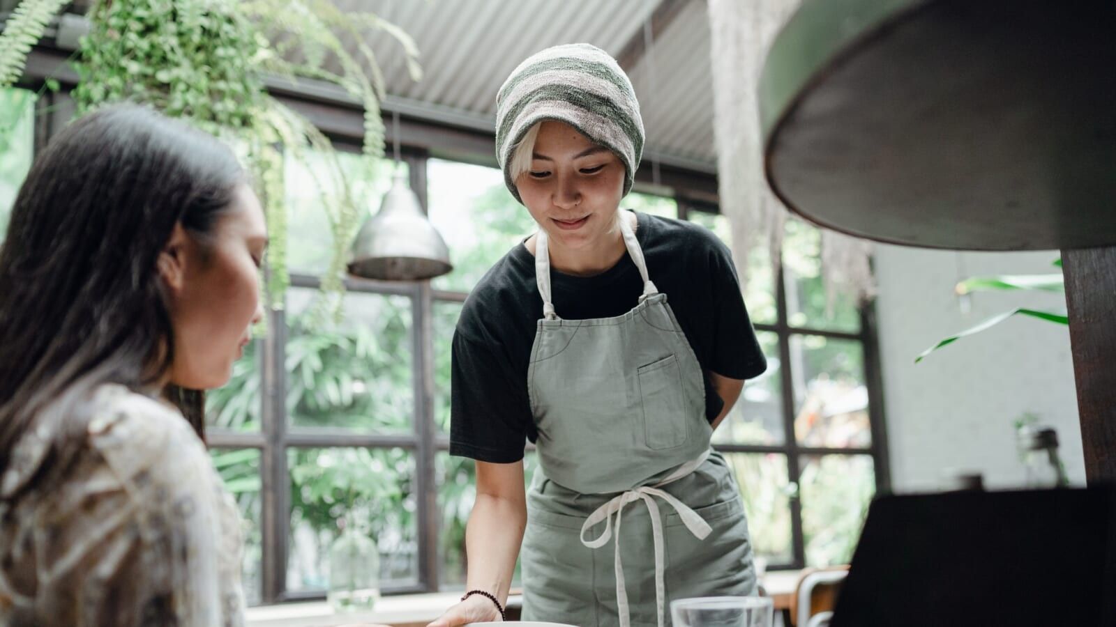 smiling waitress serving customer