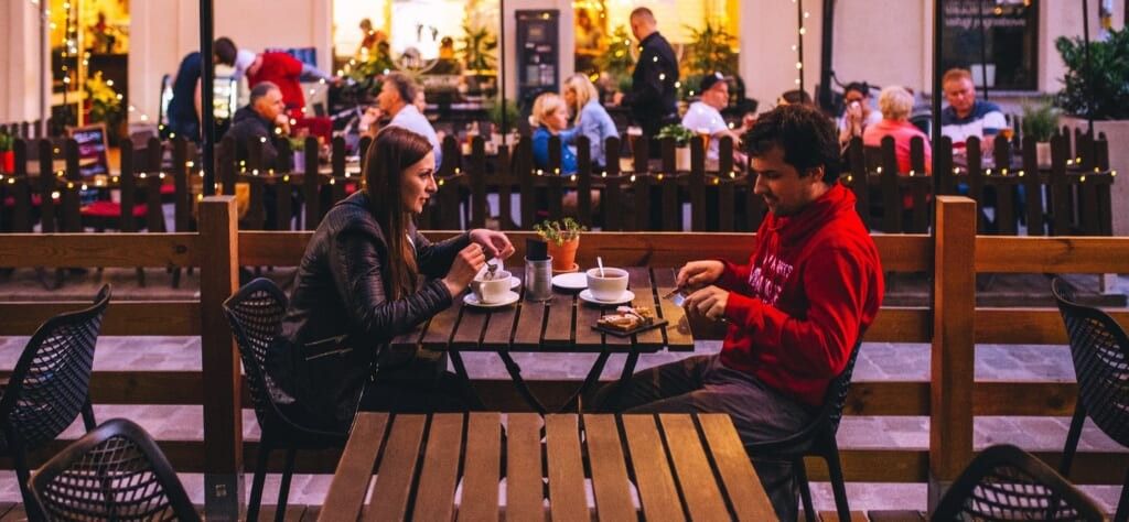 couple chats at table on date