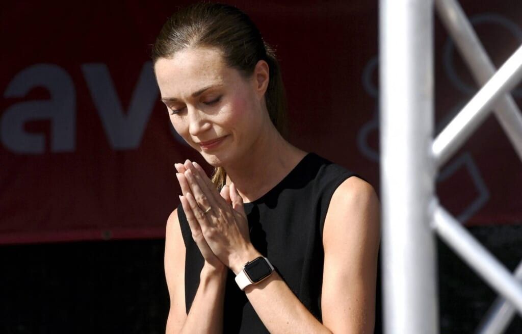 Finland Prime Minister Sanna Marin with hands in prayer.