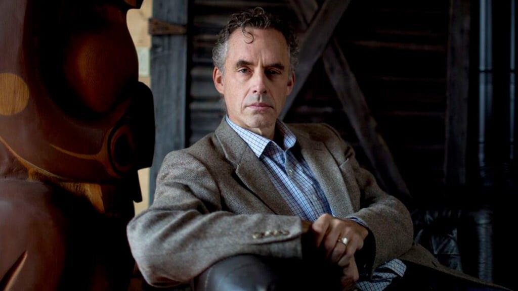Jordan Peterson reclining on a leather couch