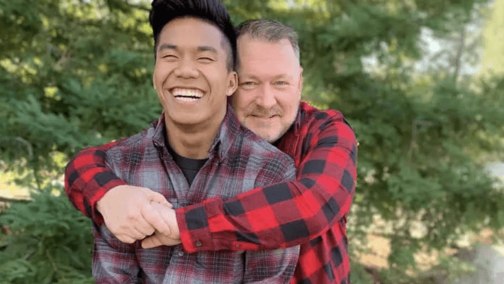 father hugging his son