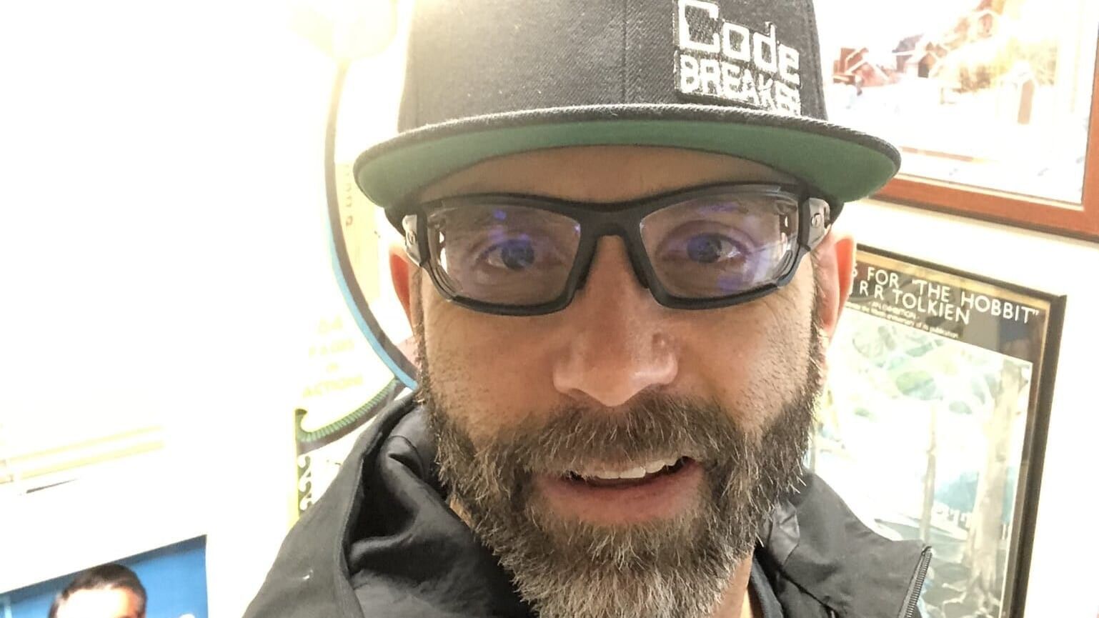 man wearing glasses and a cap