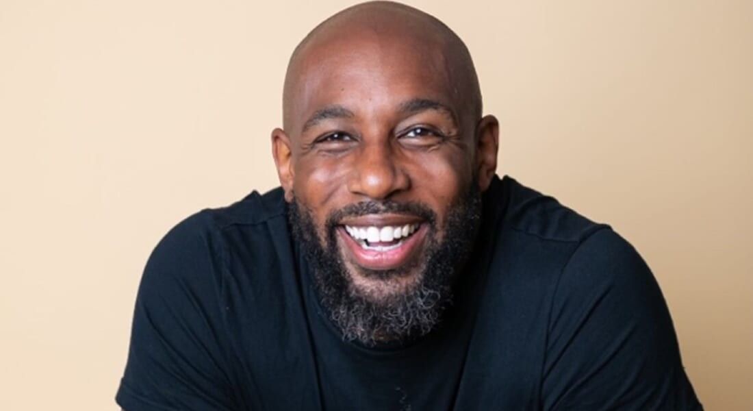 Stephen tWitch Boss wearing a black shirt and smiling at the camera.