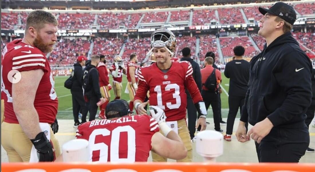 Brock Purdy taking a break from football on the field. 