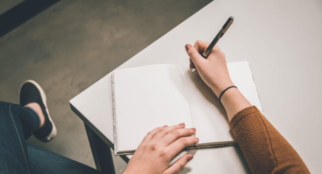 female hands writing blank pages