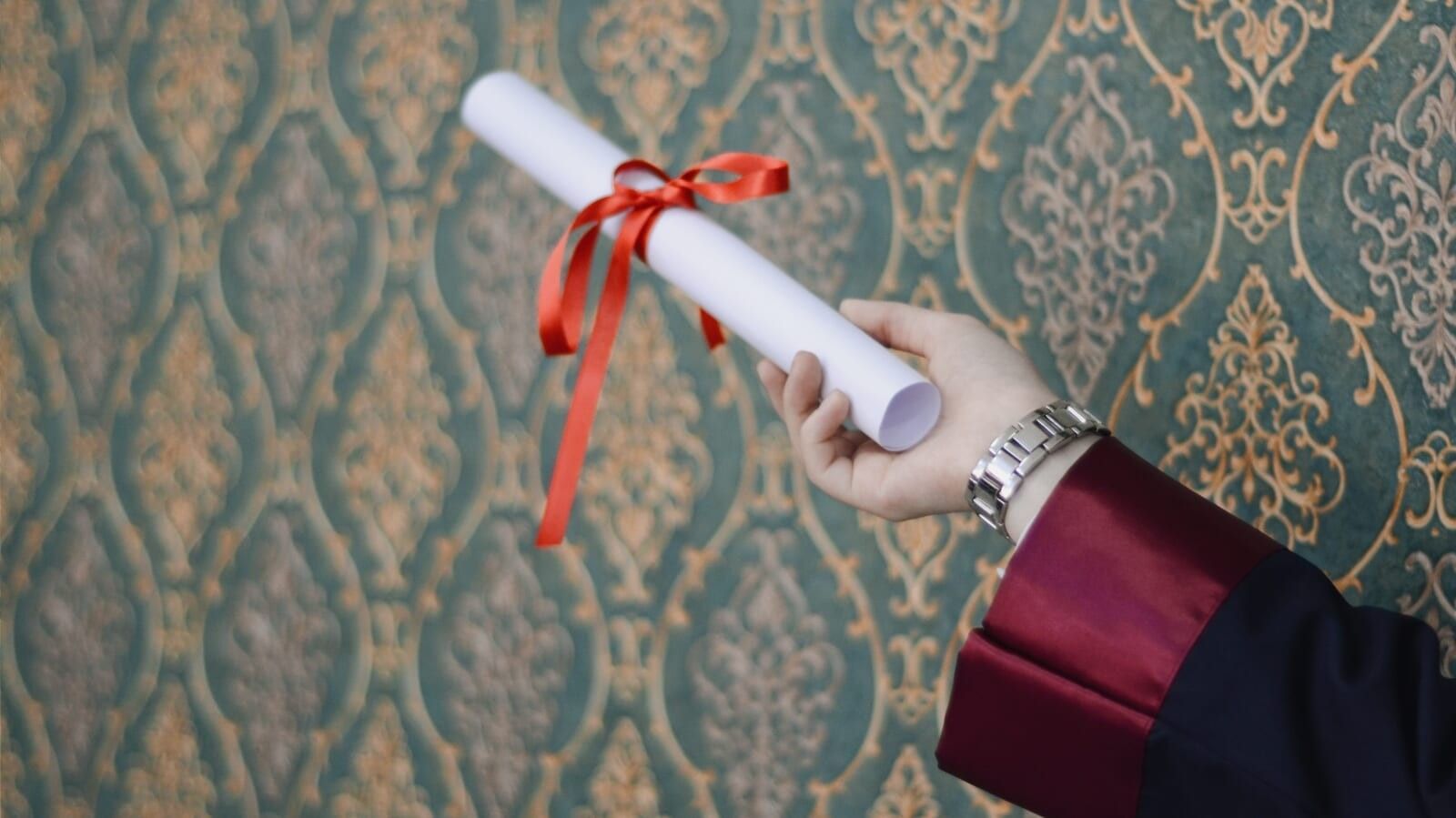 person holding a degree in their hands