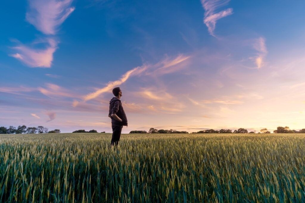 man-contemplating-life-in-field