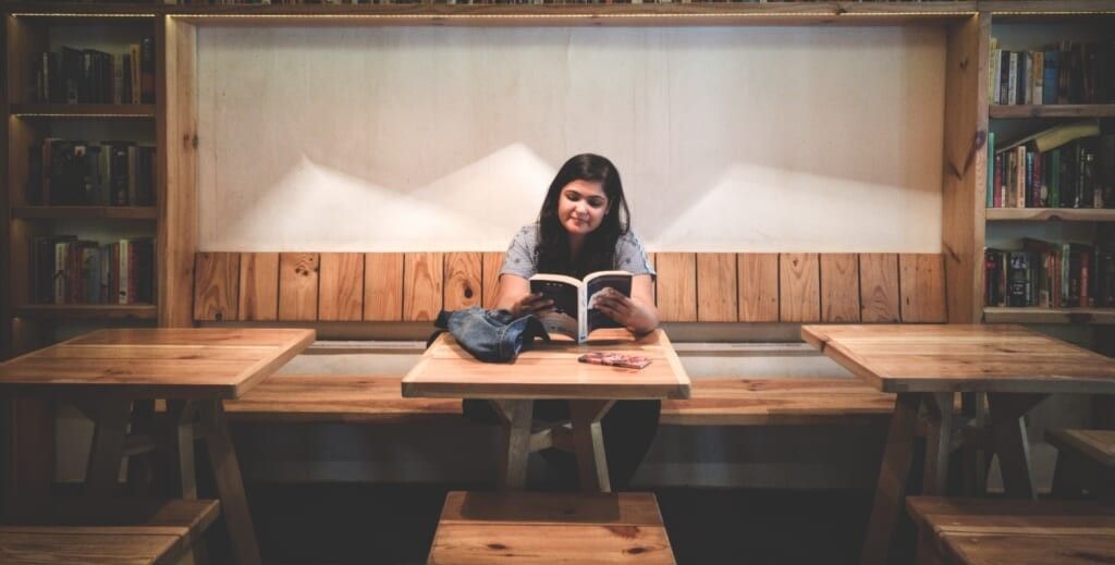 young woman studies in empty room