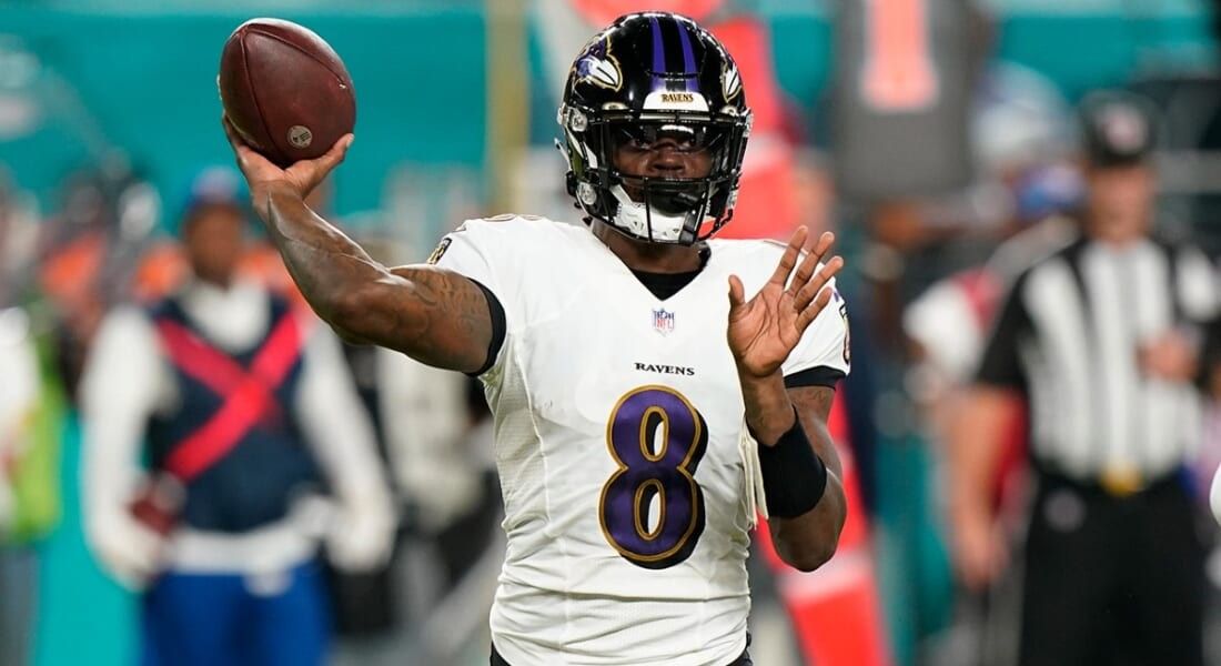 Lamar Jackson in 8 Jersey throwing the football. 