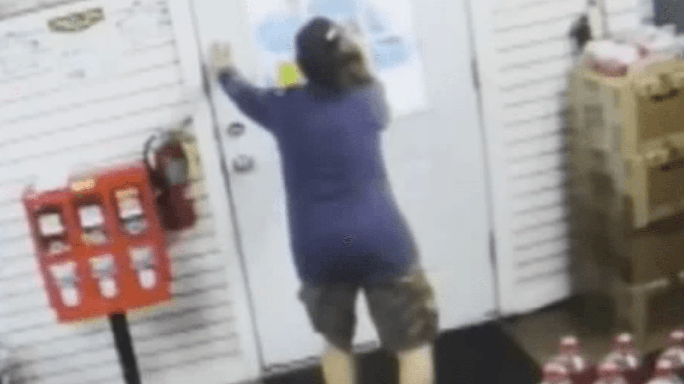 woman wearing shirt and shorts knocking on a door