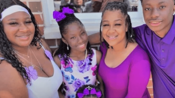 four people wearing purple