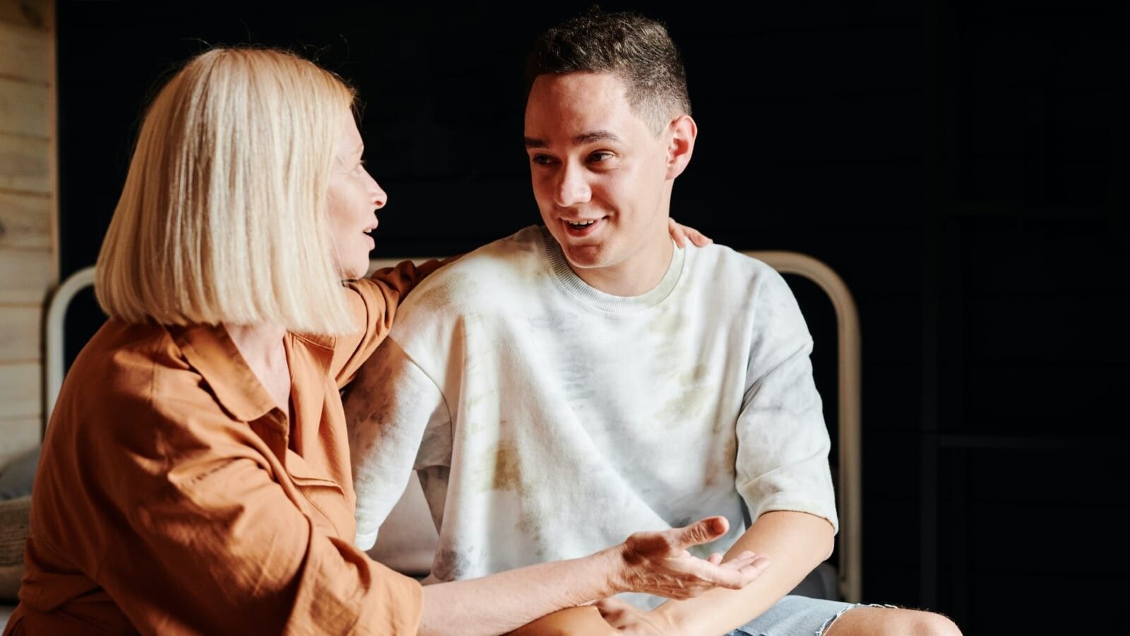 woman hugging a younger man