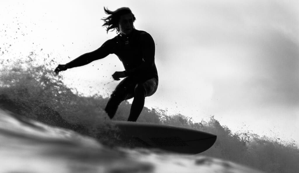 young person surfing on the water