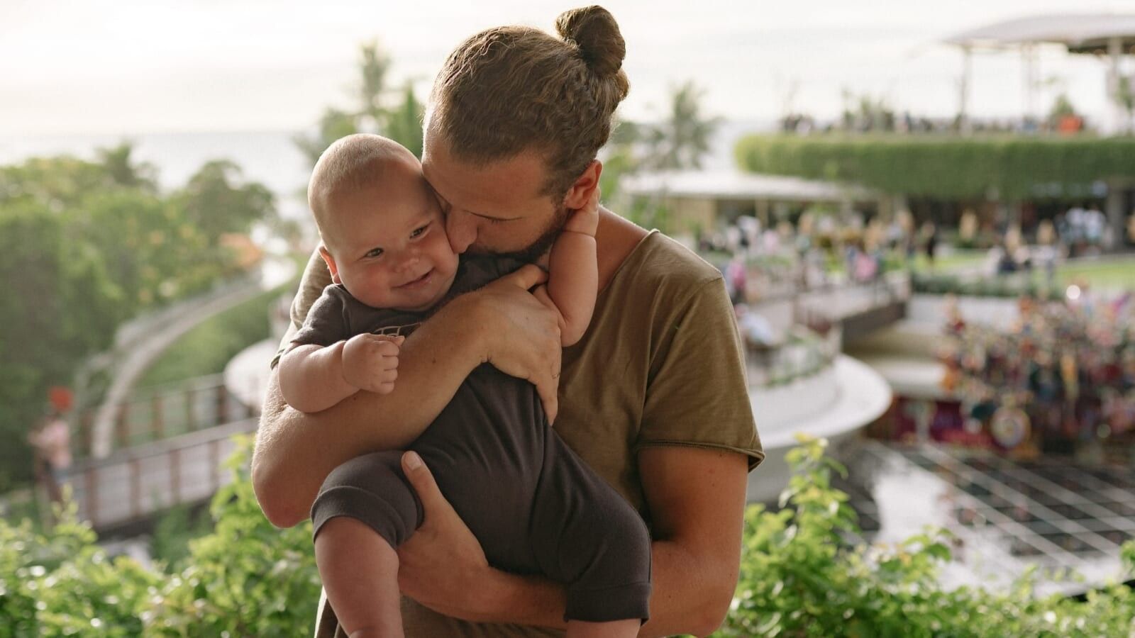 man kissing a baby