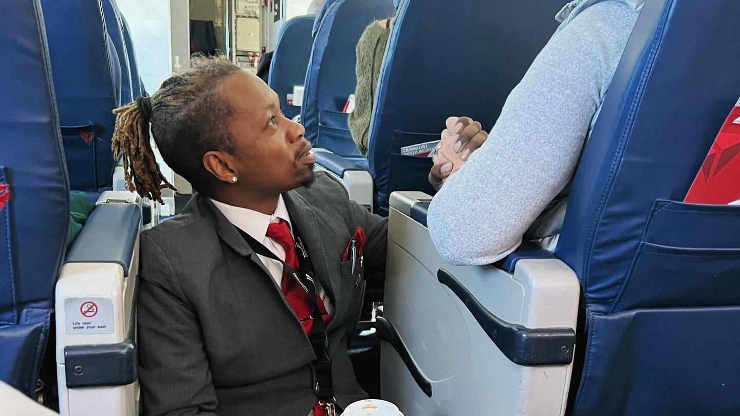 flight attendant holding passenger