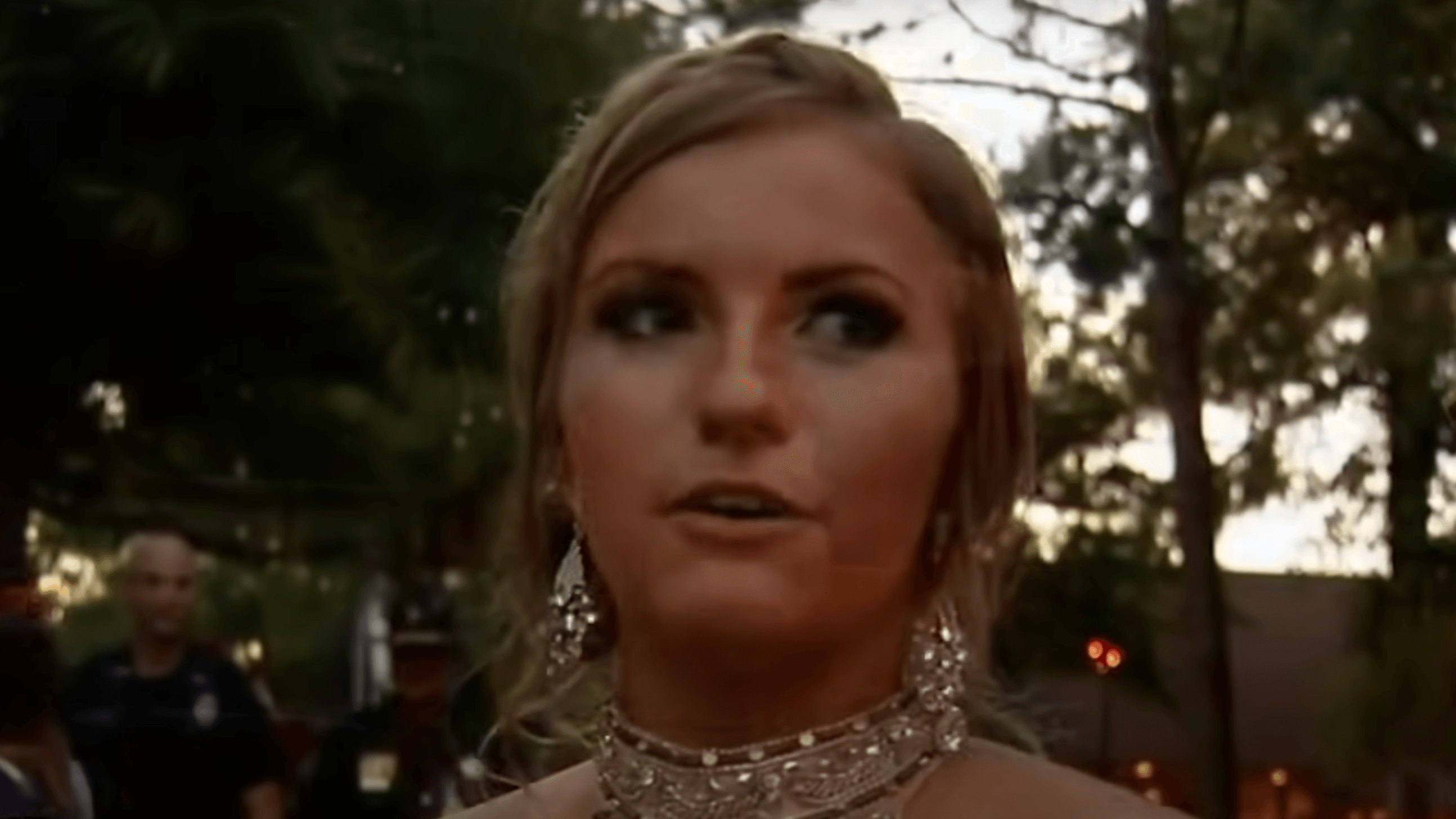 young woman wearing a sparkly necklace and earrings