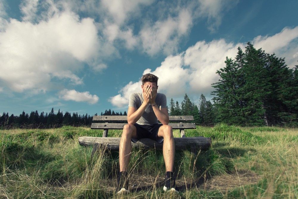 man-hiding-his-face-self-sabotage