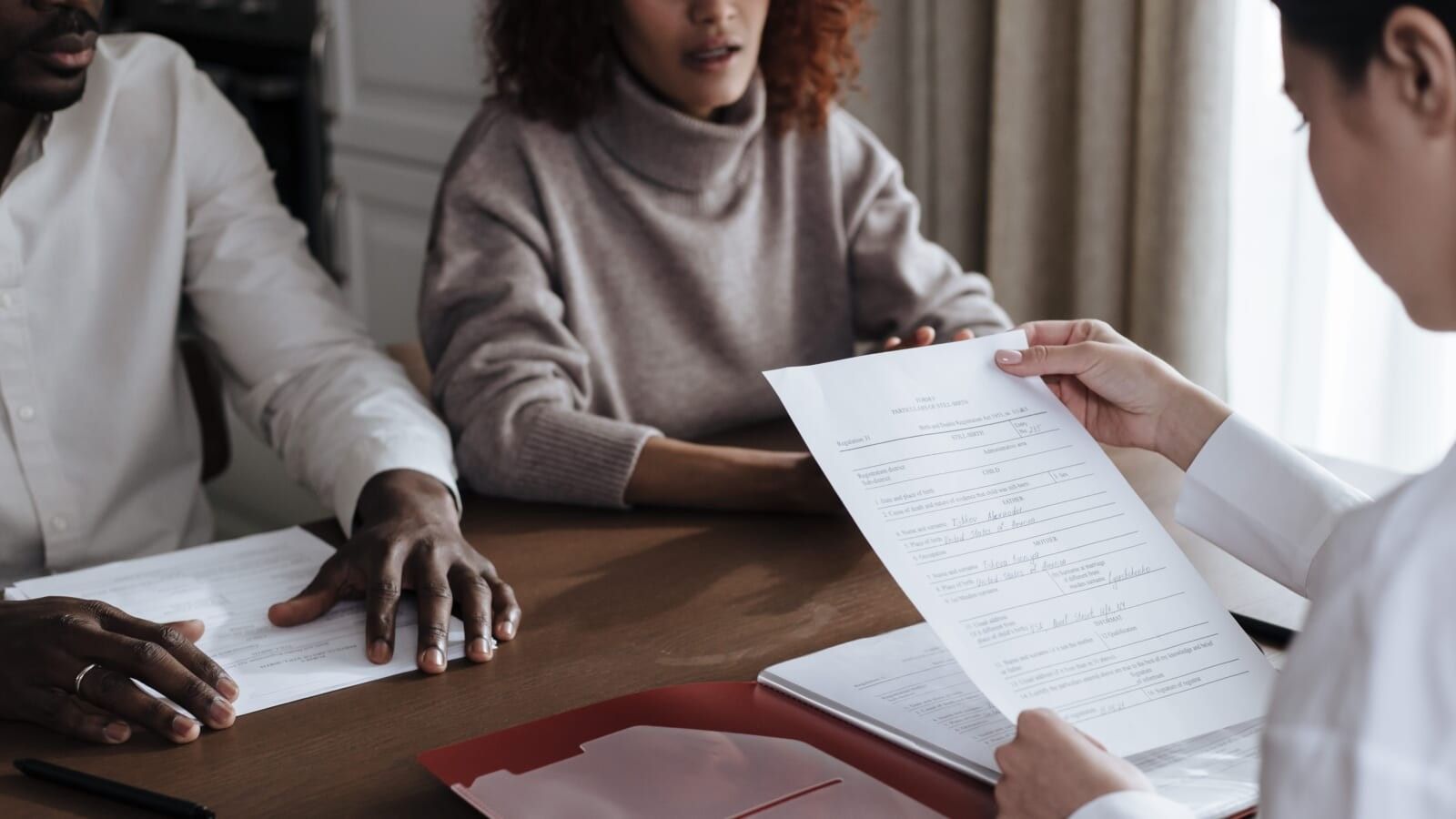 couple signing adoption papers
