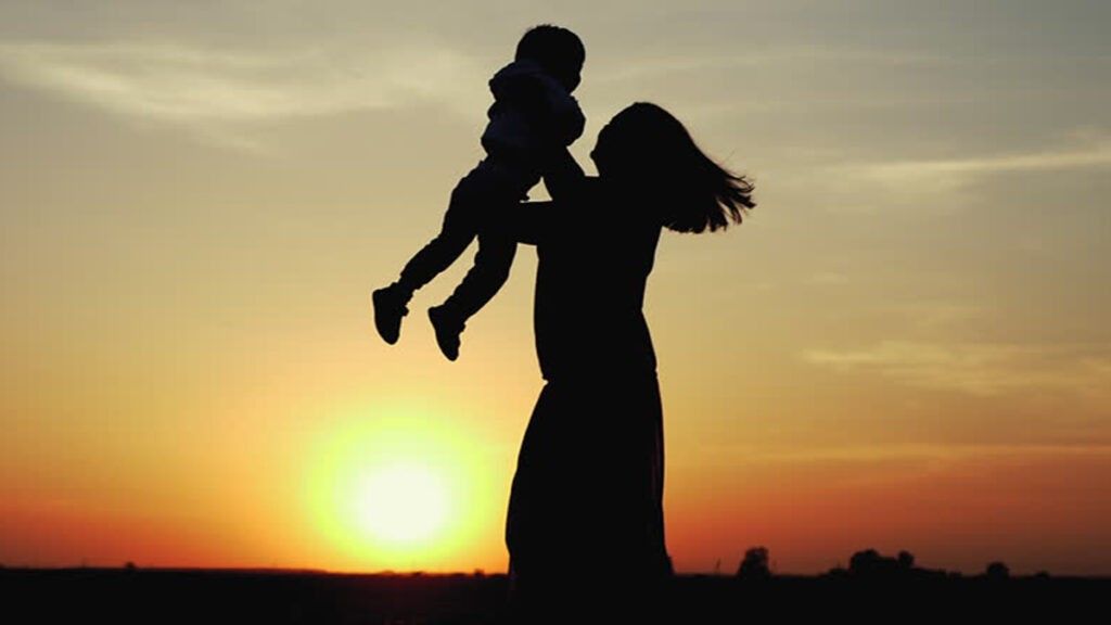 Mother and son silhouette against a sunseet backdrop 1024x576