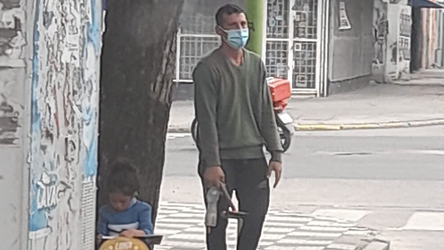 a man standing while his daughter does homework