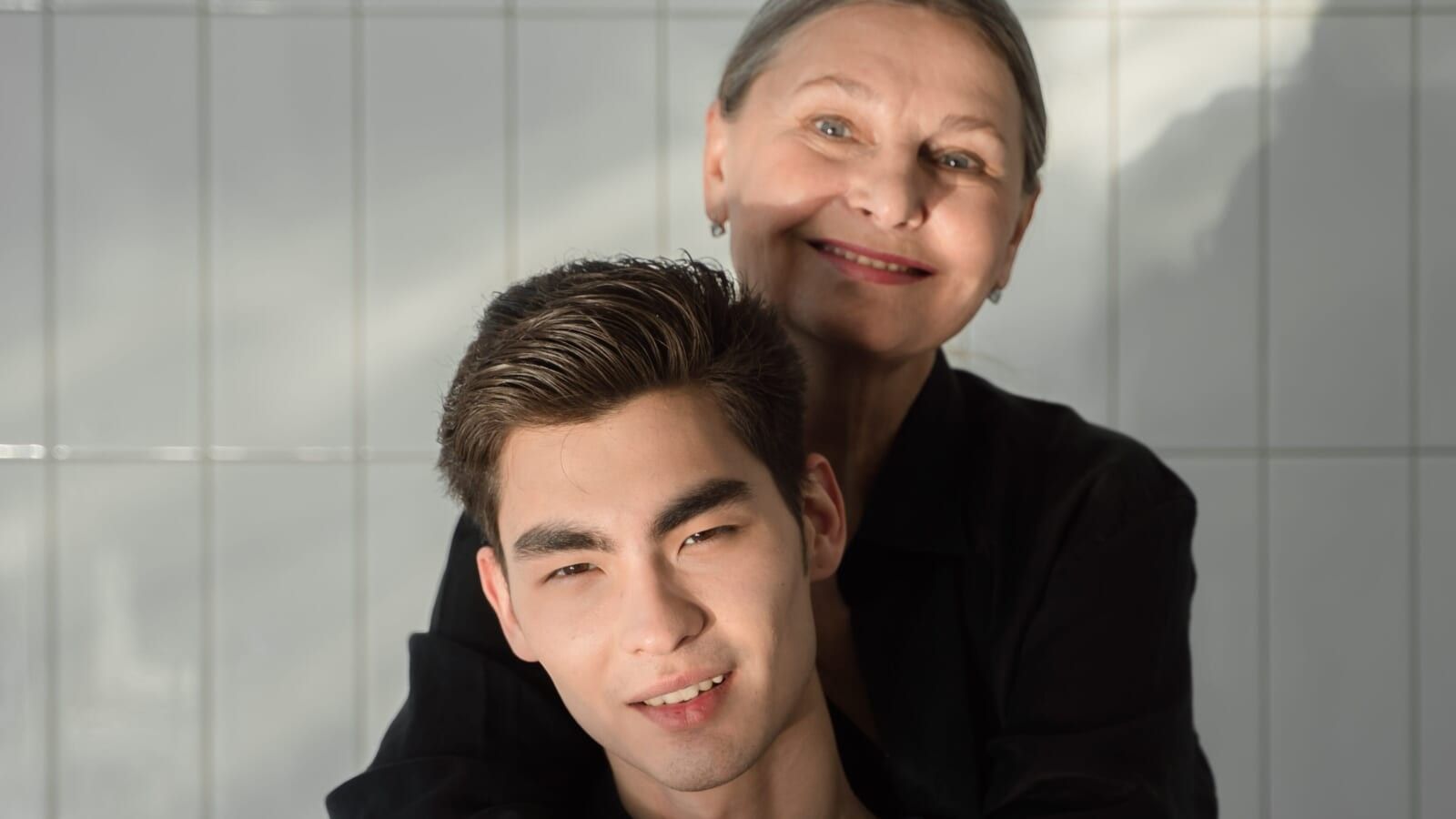 older woman hugging a younger man
