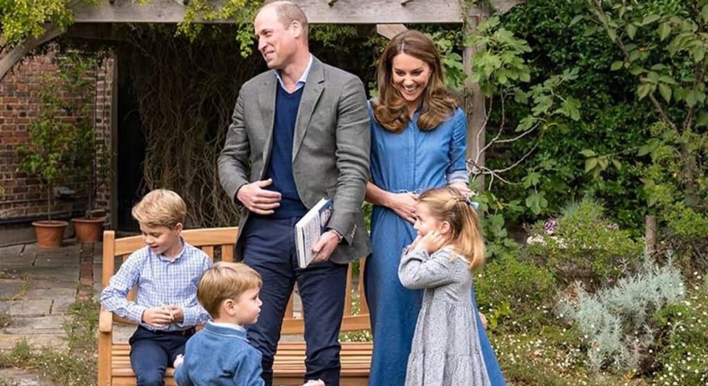 Prince William and Kate Middleton laughing during a family photo.