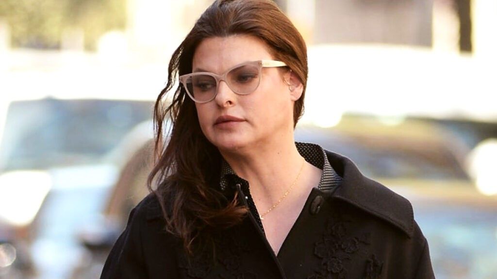 Linda Evangelista wearing glasses in the street