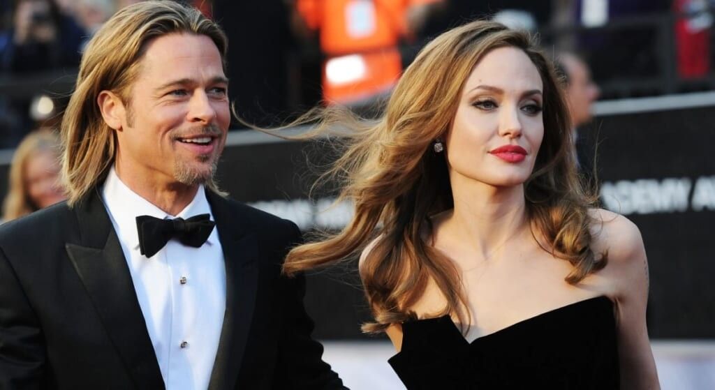 Brad PItt in tuxedo with Angelina Jolie in black dress.