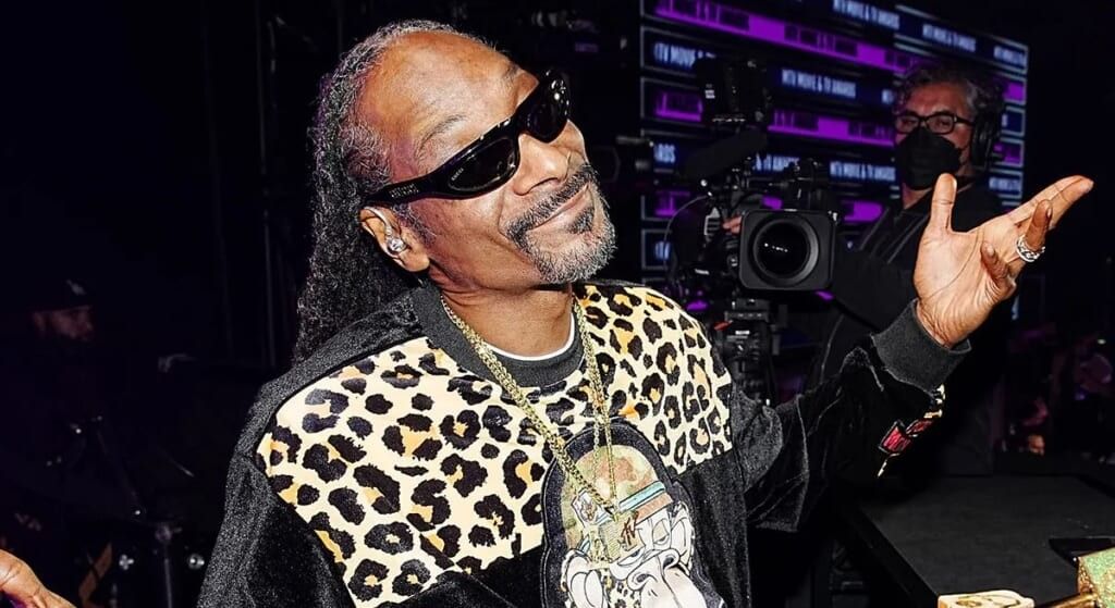 Snoop Dog with his hans in the air during a recording session.