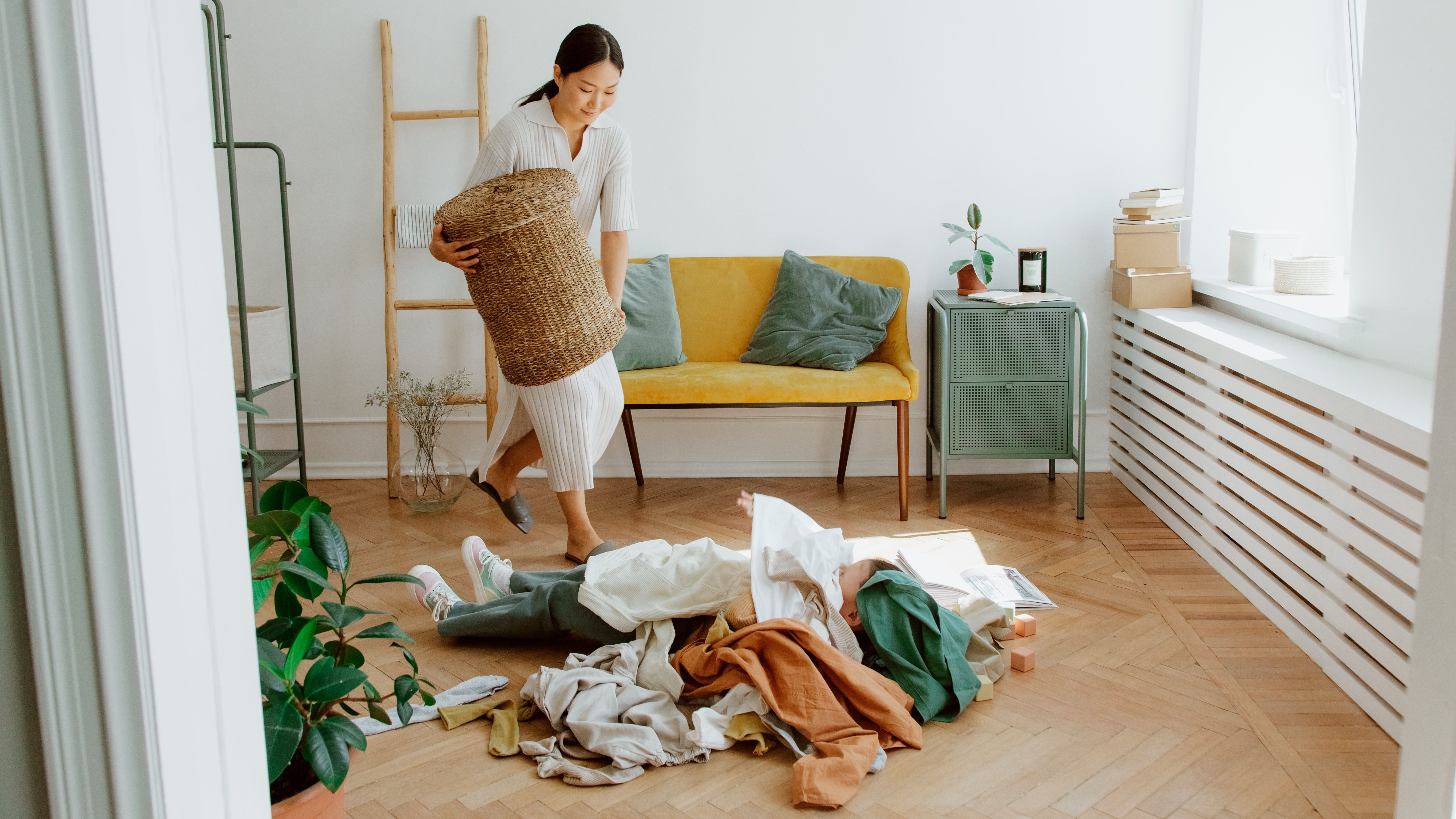woman picking up clothes from the floor