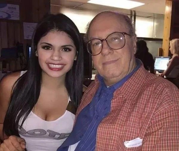 Hooters server with an elderly man