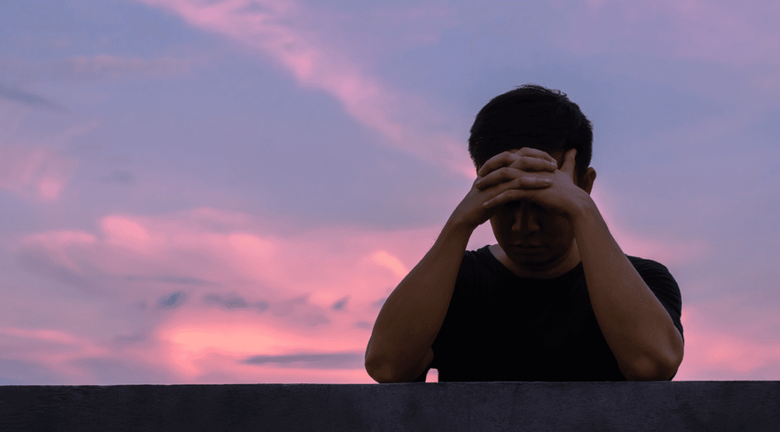 man upset head in hands