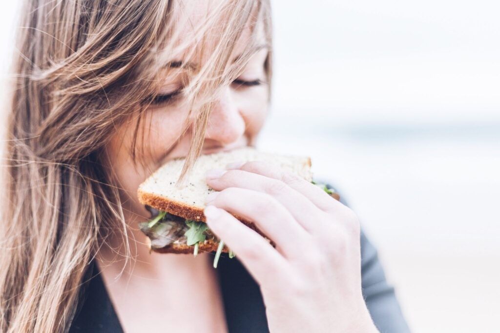 woman-biting-into-sandwich 