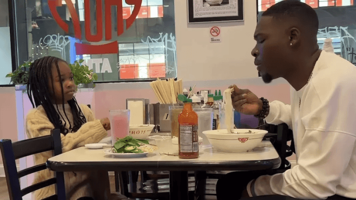 man eating with his daughter